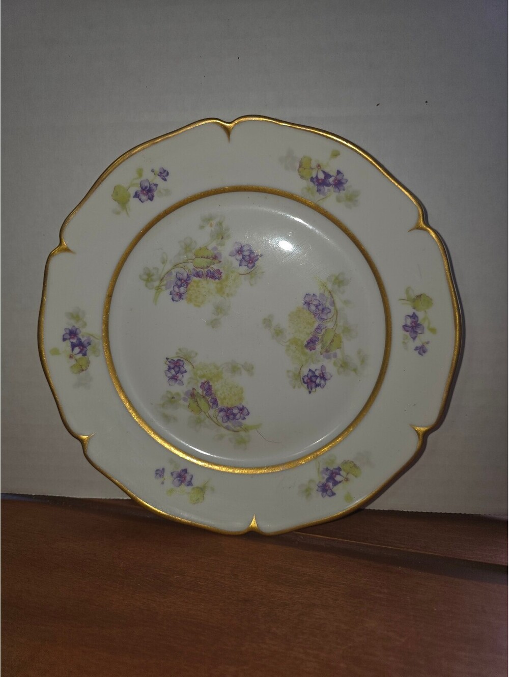 Vintage porcelain plate with purple flowers